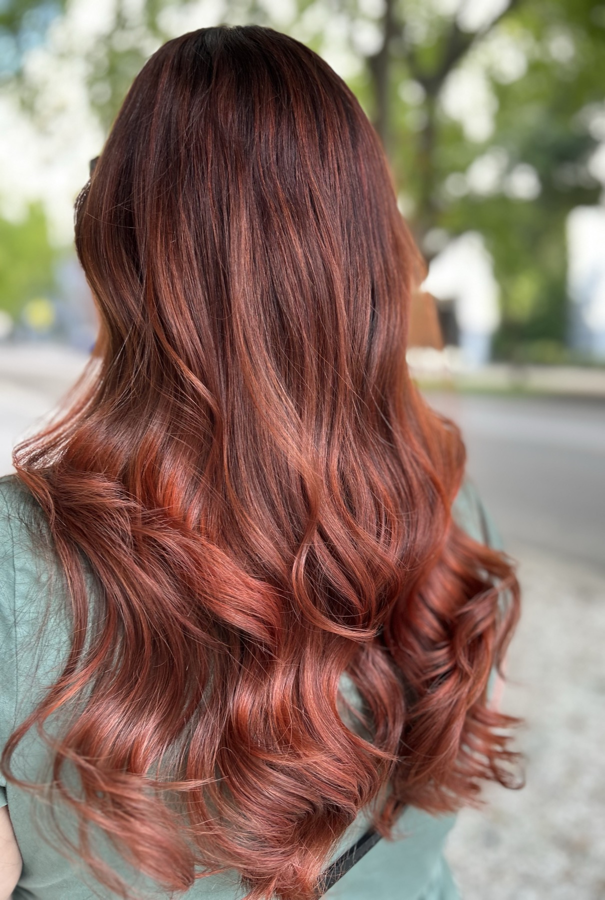 Rich copper-red hair styled in loose waves