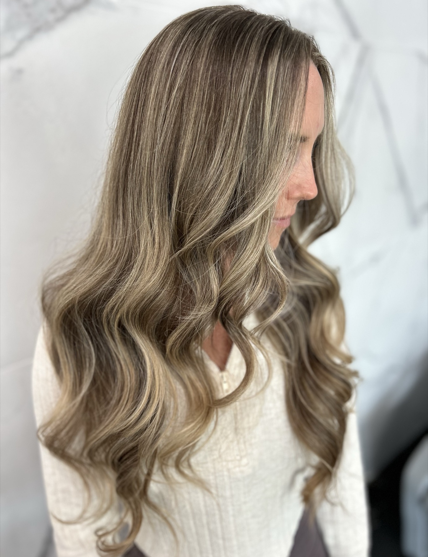 Soft blonde waves with face-framing highlights